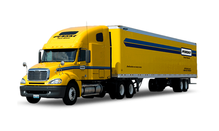 Heavy-duty trailer transporting large equipment on the road.